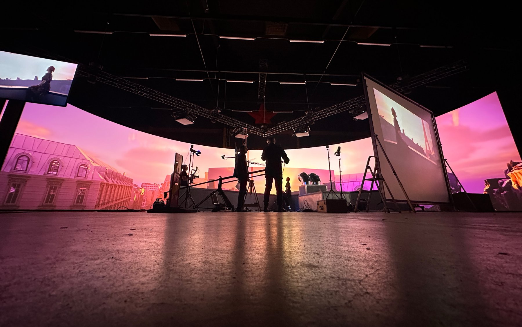 Fotografi av inspelning av en scen i Paris med rosa solnedgång, filmad med hjälp av Virtual Production inne i Ystad Studios
